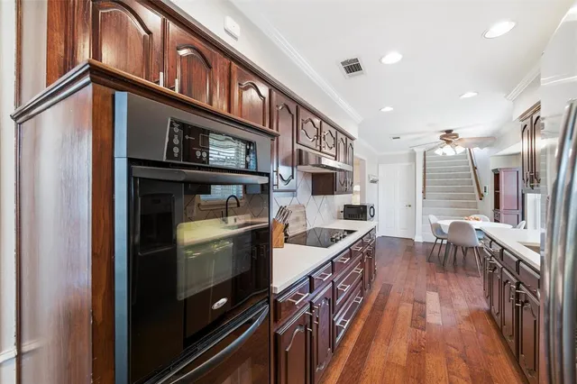 a kitchen with stainless steel appliances granite countertop a stove and a refrigerator