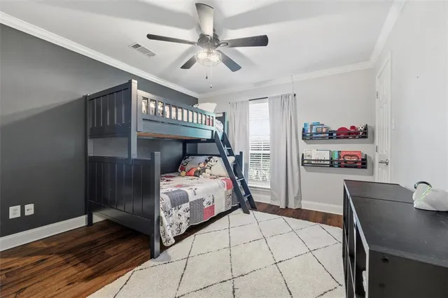 a bedroom with bed and a chandelier