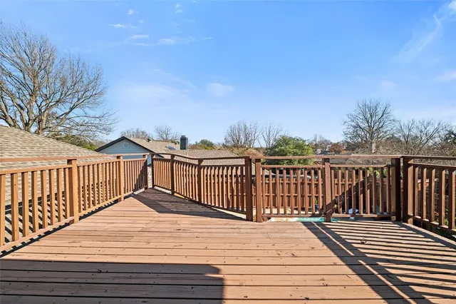 a view of balcony with wooden floor and fence