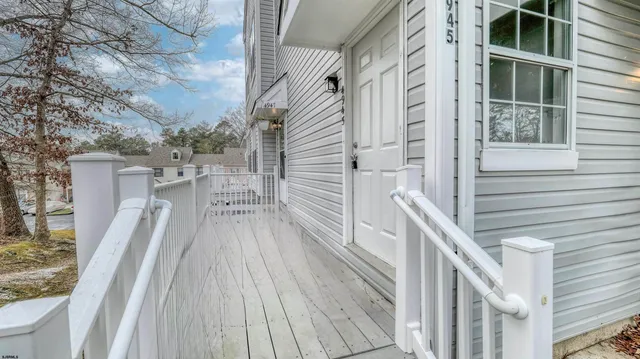 a view of balcony with wooden floor and fence