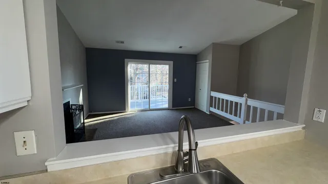 a view of an empty room with windows