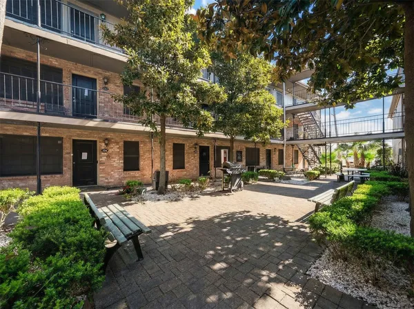 a view of a house with backyard sitting area and garden