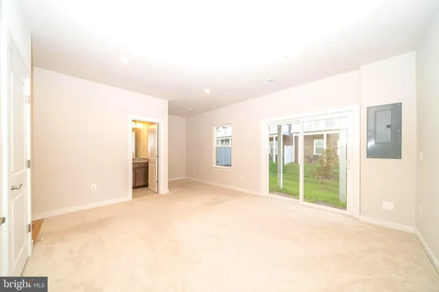 a view of an empty room with glass door