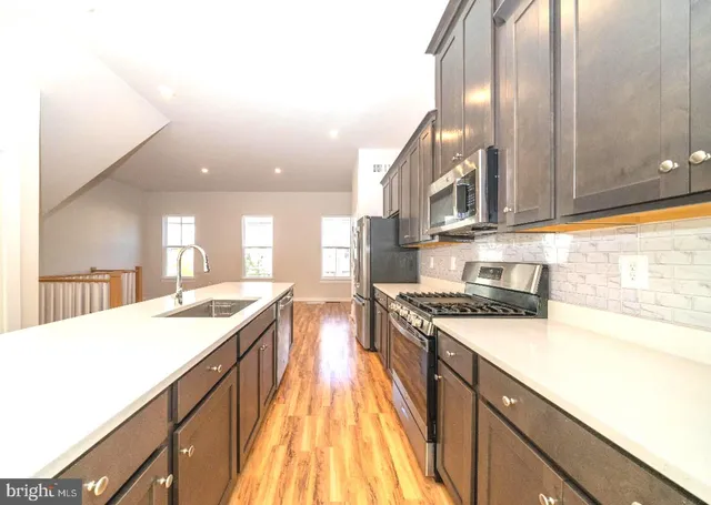 a kitchen with a sink stove and cabinets
