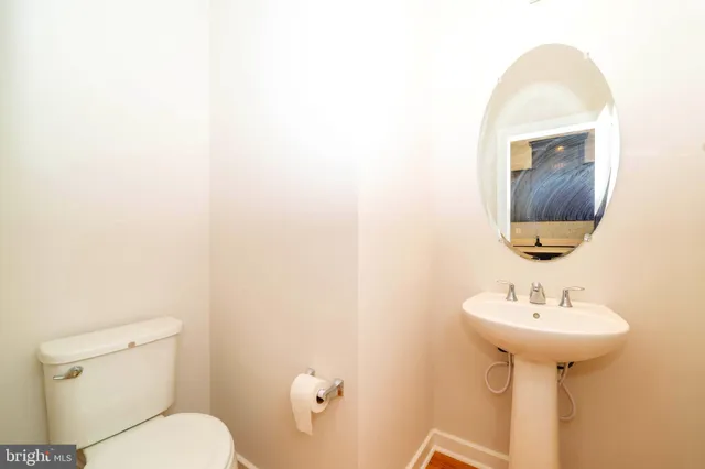 a bathroom with a sink toilet and mirror