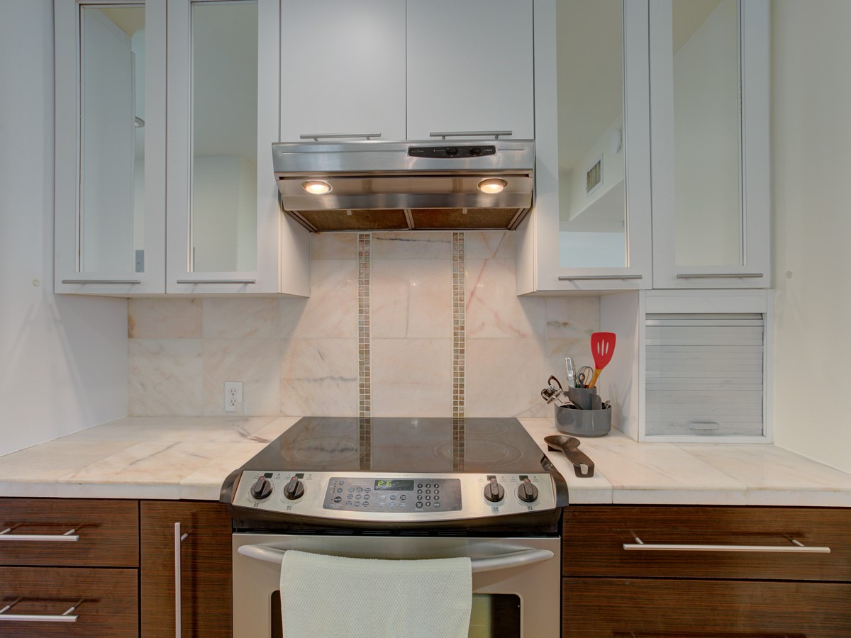 710 Castle Ridge Road, Unit B Austin, TX 78746 - Photo 10 of 27 Culinary delights await in this modern kitchen, featuring sleek countertops and functional appliances.