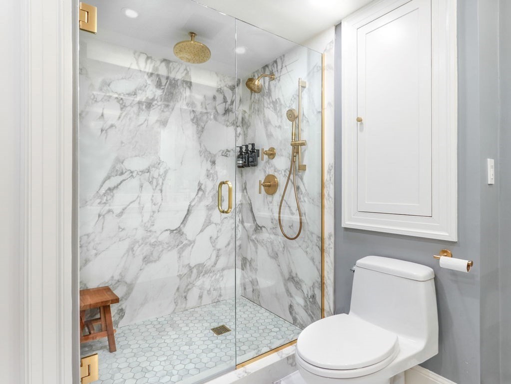 206 Beacon Street, Unit 1 Boston, MA 02116 - Photo 13 of 23 a white toilet sitting next to a bathroom shower