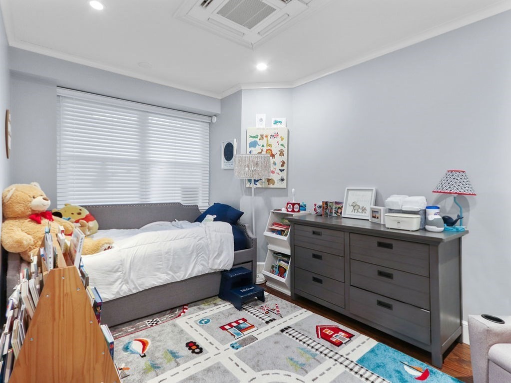206 Beacon Street, Unit 1 Boston, MA 02116 - Photo 15 of 23 a bedroom with a bed and wooden floor