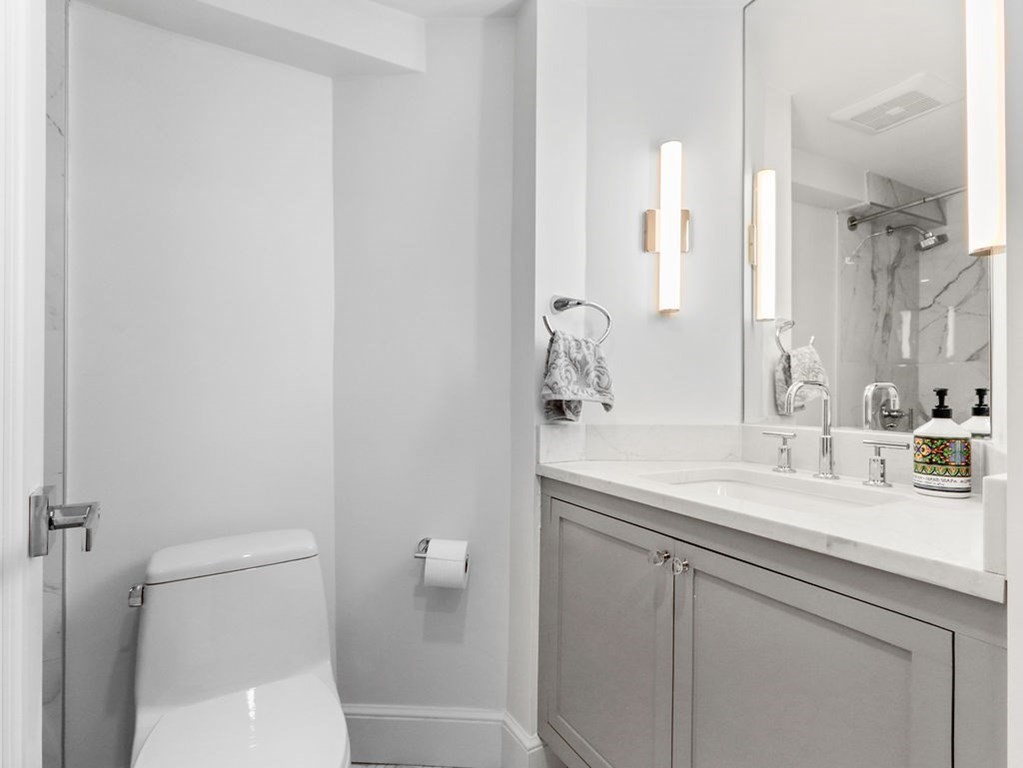 206 Beacon Street, Unit 1 Boston, MA 02116 - Photo 16 of 23 a bathroom with a sink a toilet and a mirror