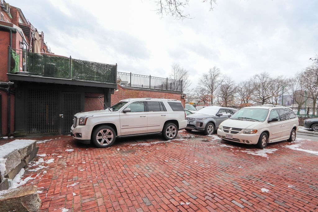 206 Beacon Street, Unit 1 Boston, MA 02116 - Photo 20 of 23 a view of a car parked in front of a house
