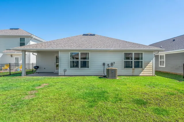 a view of a house with a backyard