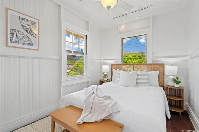 a bedroom with a bed and a painting on the wall