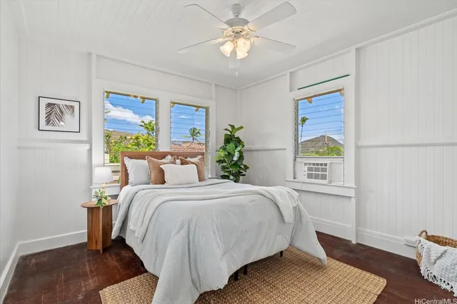 a bedroom with a bed lamp and a window