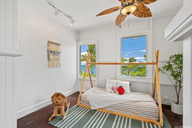a bedroom with a bed a chandelier and dresser