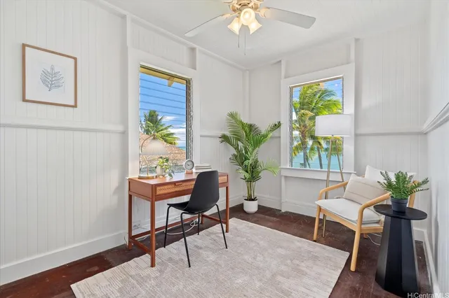a living room with furniture and a potted plant