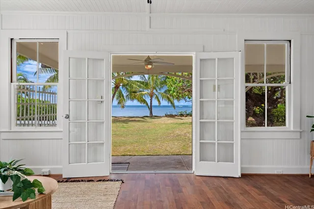 an empty room with wooden floor and a window