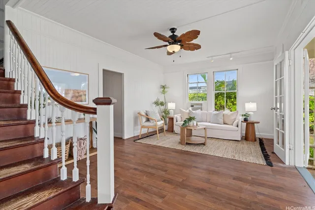 a living room with wooden floor furniture and a window
