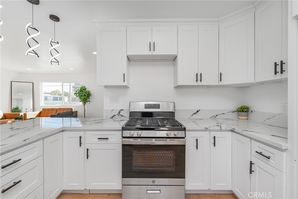 7201 Cerritos Avenue Stanton, CA 90680 - Photo 12 of 35 a kitchen with granite countertop white cabinets and white appliances