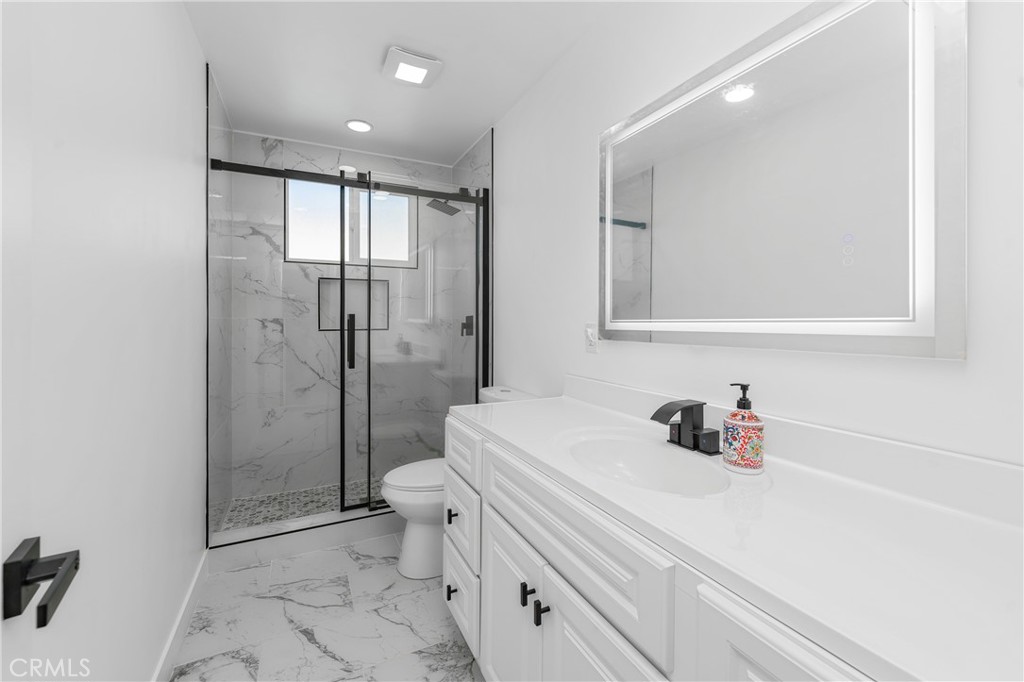 7201 Cerritos Avenue Stanton, CA 90680 - Photo 18 of 35 a bathroom with a sink toilet and shower