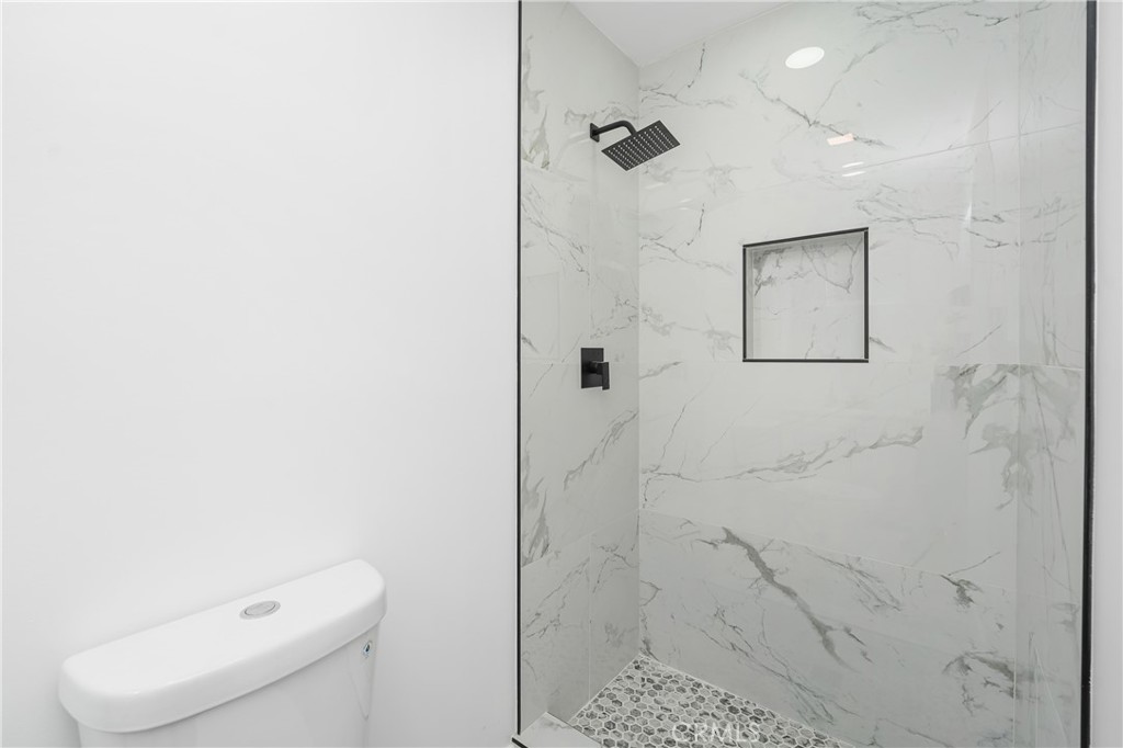 7201 Cerritos Avenue Stanton, CA 90680 - Photo 28 of 35 a bathroom with a toilet and a shower