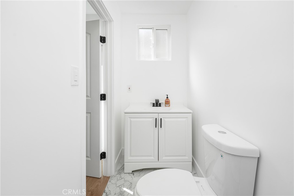 7201 Cerritos Avenue Stanton, CA 90680 - Photo 29 of 35 a white toilet sitting next to a bathroom sink