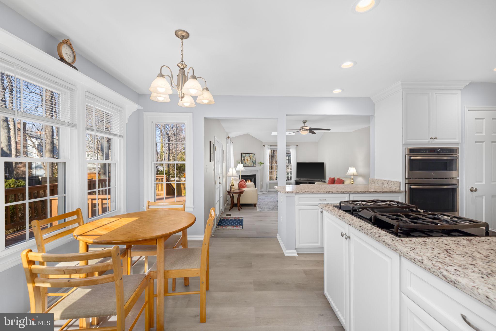 9451 Lapstrake Lane Burke, VA 22015 - Photo 12 of 59 a kitchen with a dining table and chairs