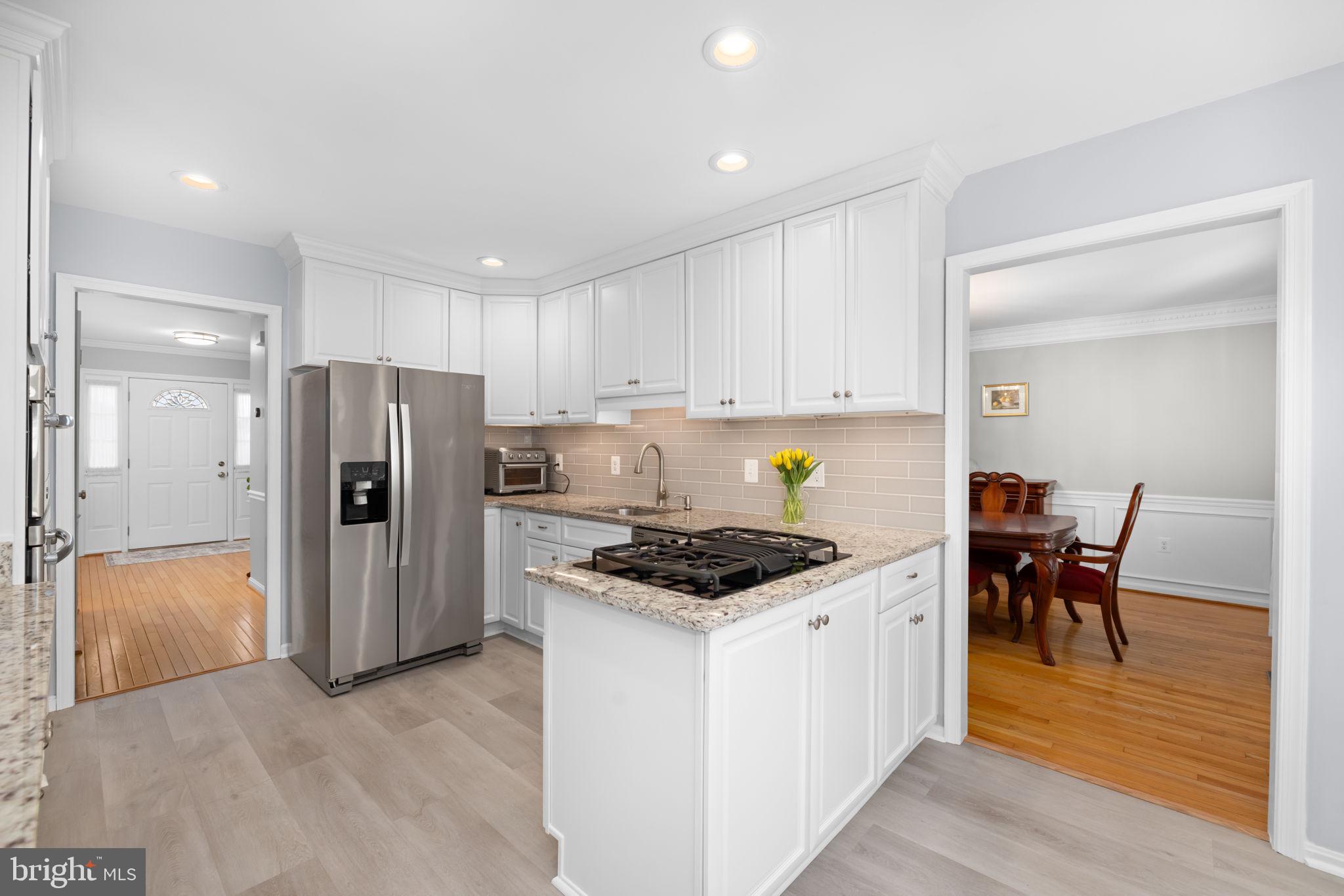 9451 Lapstrake Lane Burke, VA 22015 - Photo 15 of 59 a kitchen with a refrigerator and a stove top oven