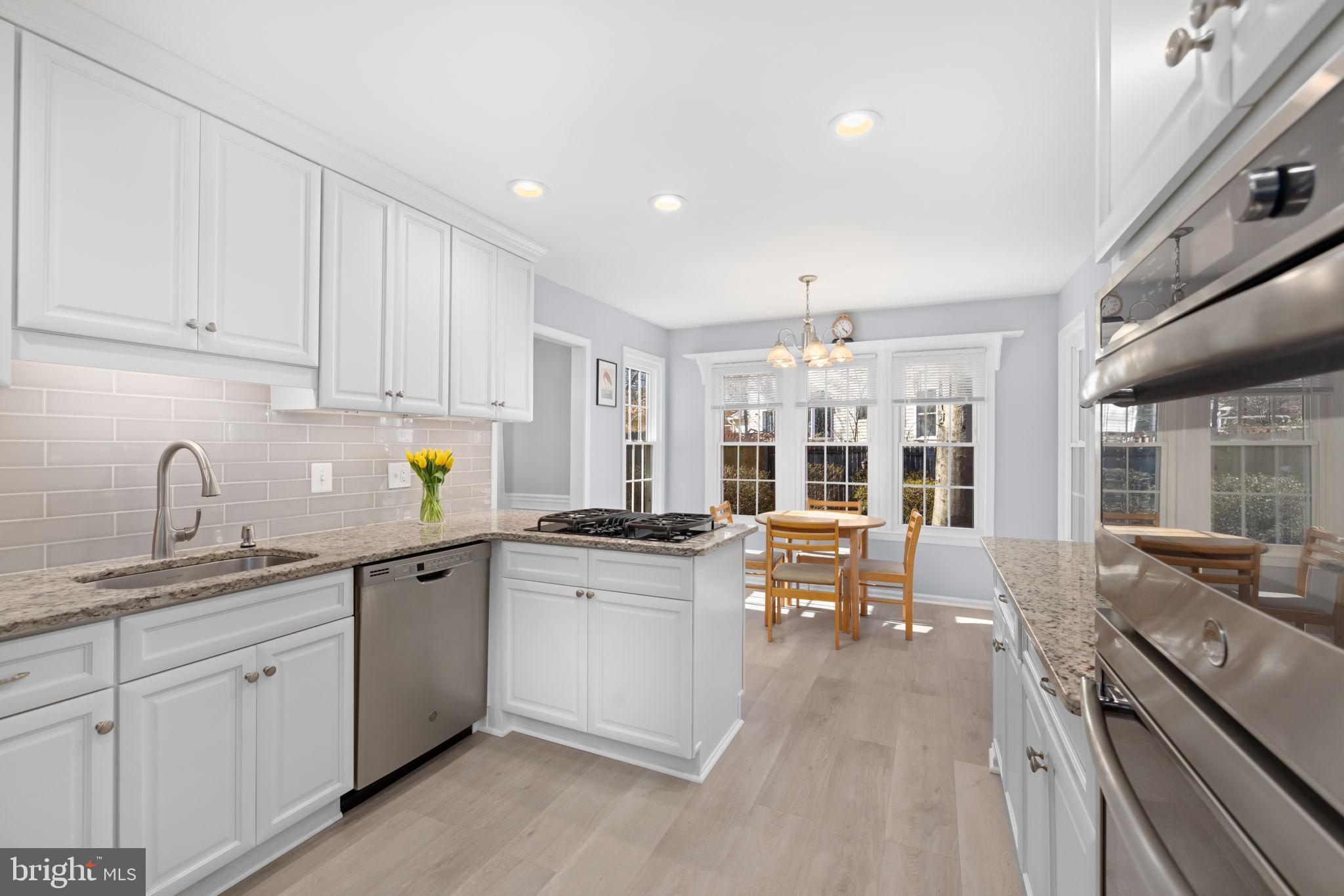 9451 Lapstrake Lane Burke, VA 22015 - Photo 16 of 59 a kitchen with a sink stove and cabinets
