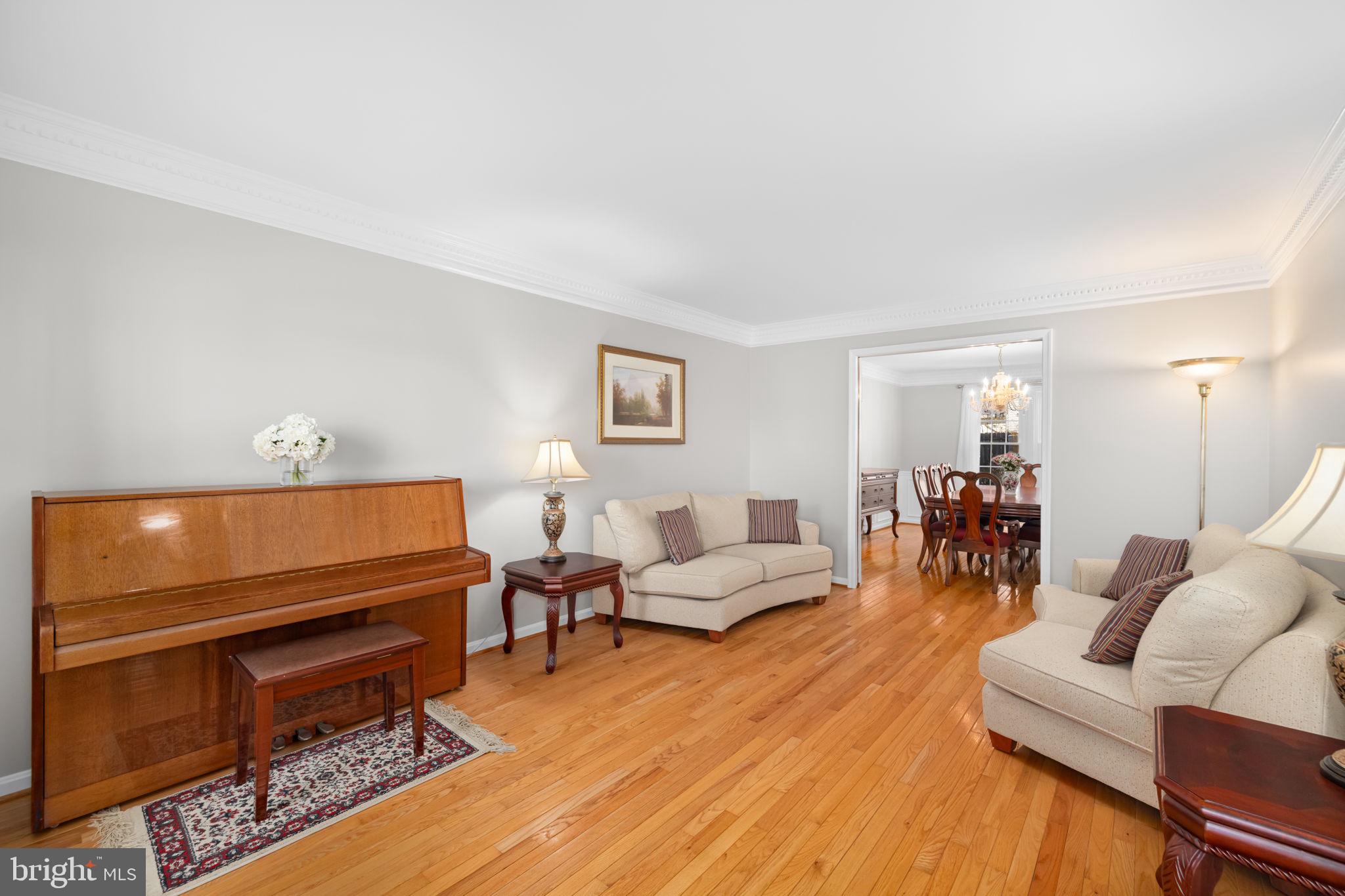 9451 Lapstrake Lane Burke, VA 22015 - Photo 18 of 59 a living room with furniture a wooden floor and a lamp