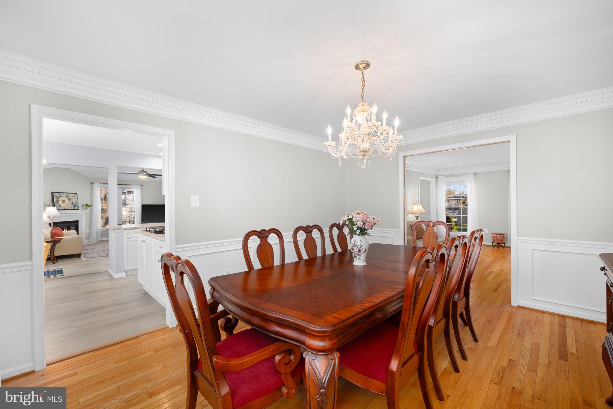 9451 Lapstrake Lane Burke, VA 22015 - Photo 21 of 59 a dining room with furniture a chandelier and wooden floor