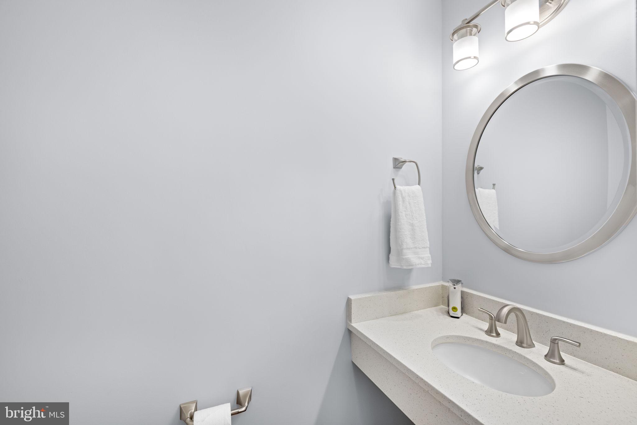 9451 Lapstrake Lane Burke, VA 22015 - Photo 23 of 59 a bathroom with a sink and a mirror
