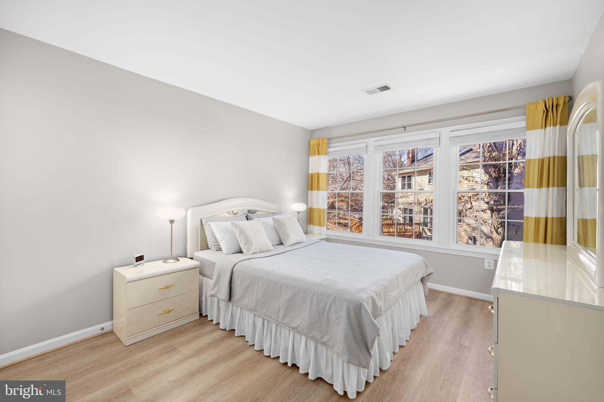 9451 Lapstrake Lane Burke, VA 22015 - Photo 33 of 59 a spacious bedroom with a bed and a large window