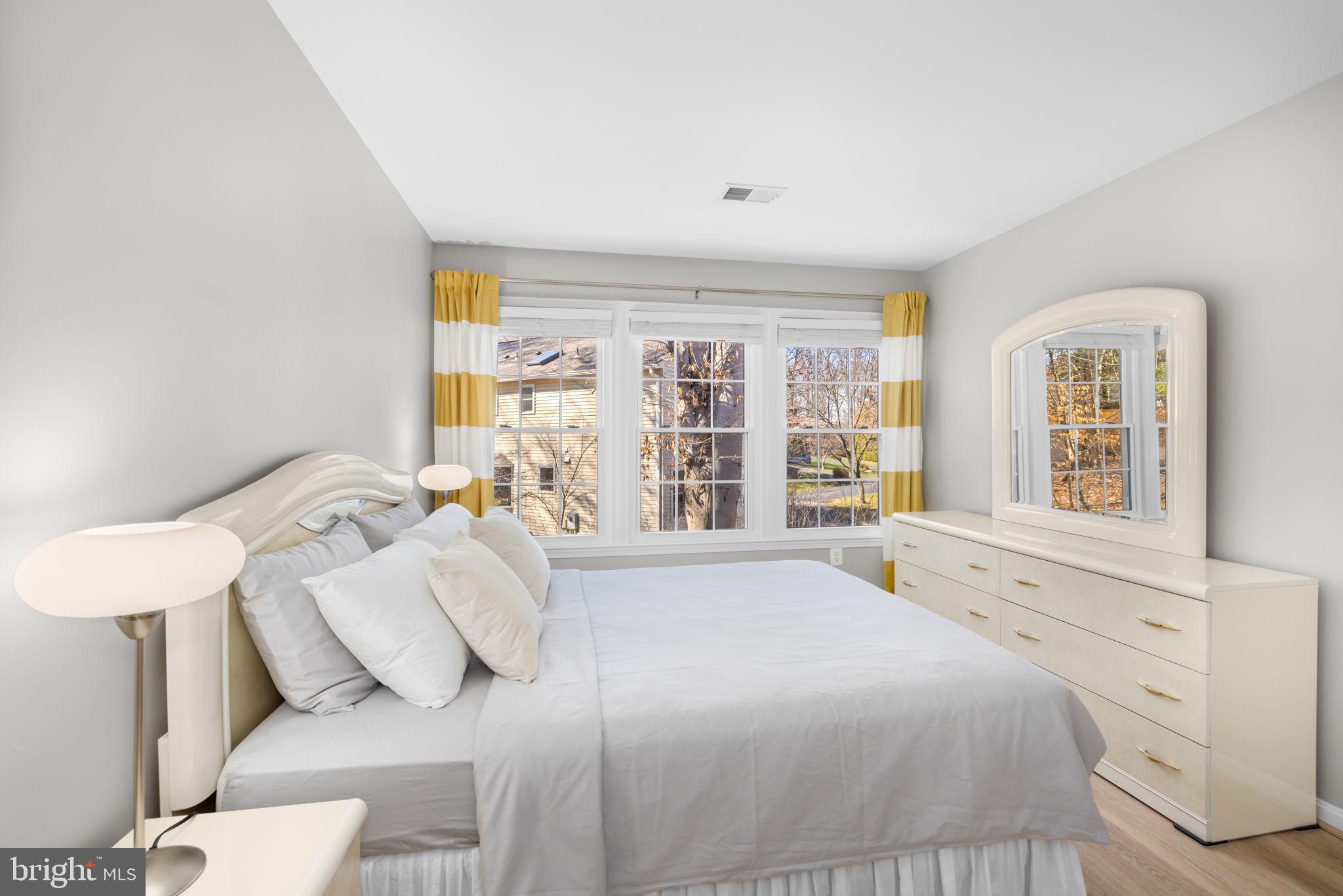 9451 Lapstrake Lane Burke, VA 22015 - Photo 34 of 59 a spacious bedroom with a bed and a large window