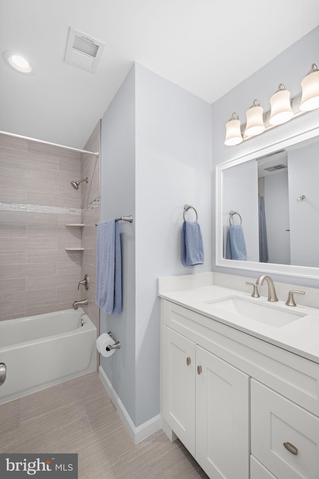 9451 Lapstrake Lane Burke, VA 22015 - Photo 38 of 59 a bathroom with a tub a sink and mirror
