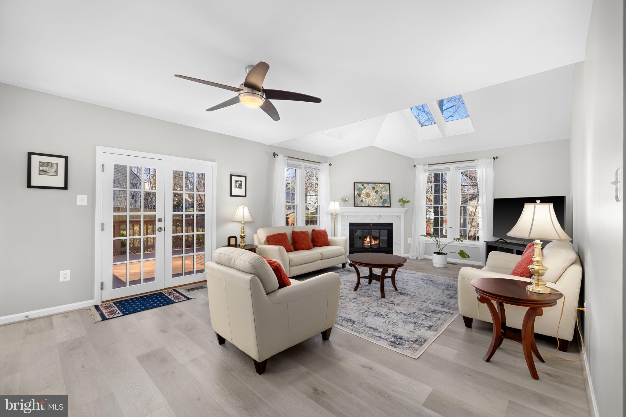 9451 Lapstrake Lane Burke, VA 22015 - Photo 4 of 59 a living room with furniture a fireplace and a flat screen tv