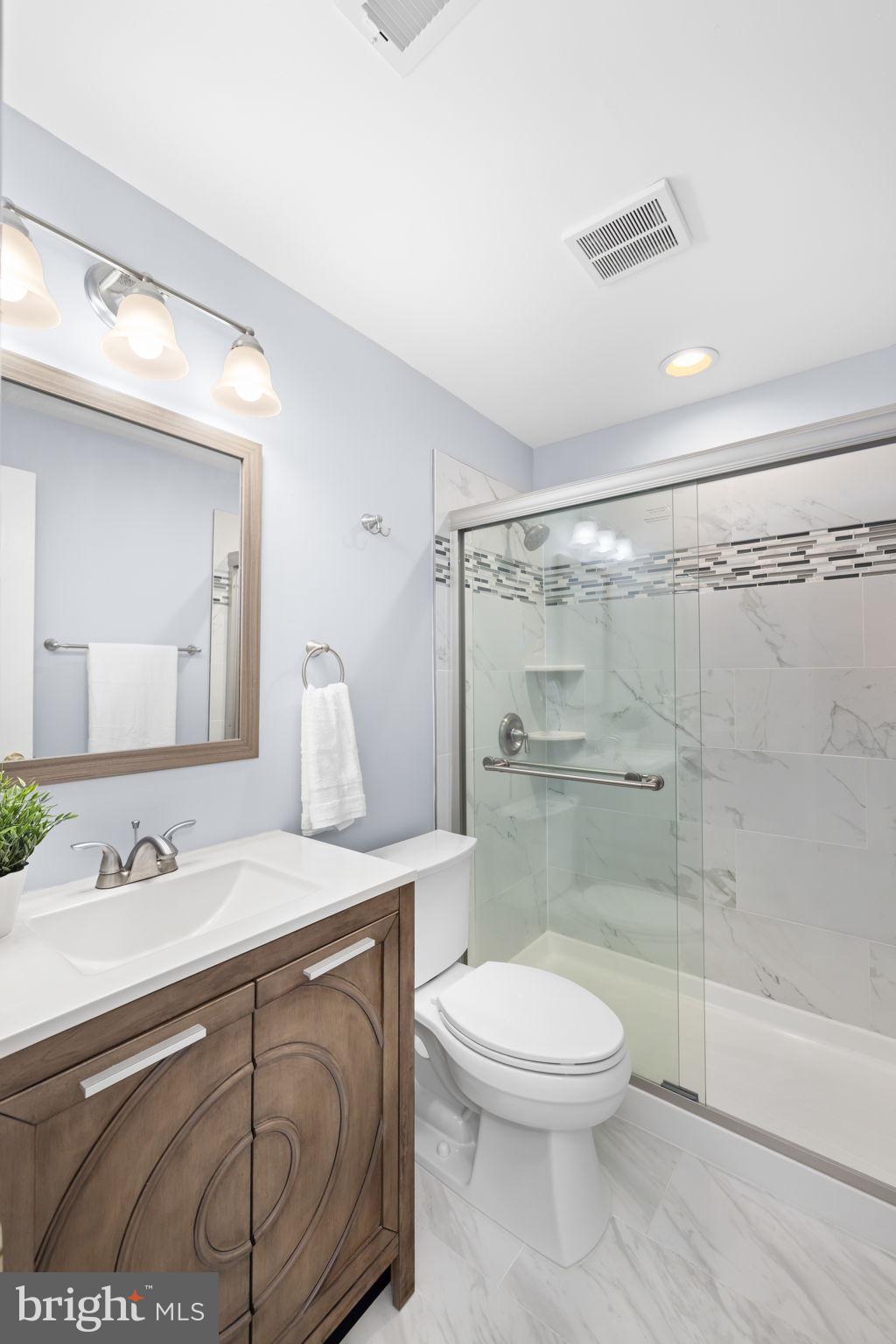 9451 Lapstrake Lane Burke, VA 22015 - Photo 43 of 59 a bathroom with a sink a toilet and shower