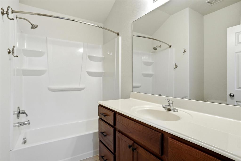 216 Meadow Ridge Drive Anna, TX 75409 - Photo 15 of 16 a bathroom with a sink double vanity mirror and a bathtub