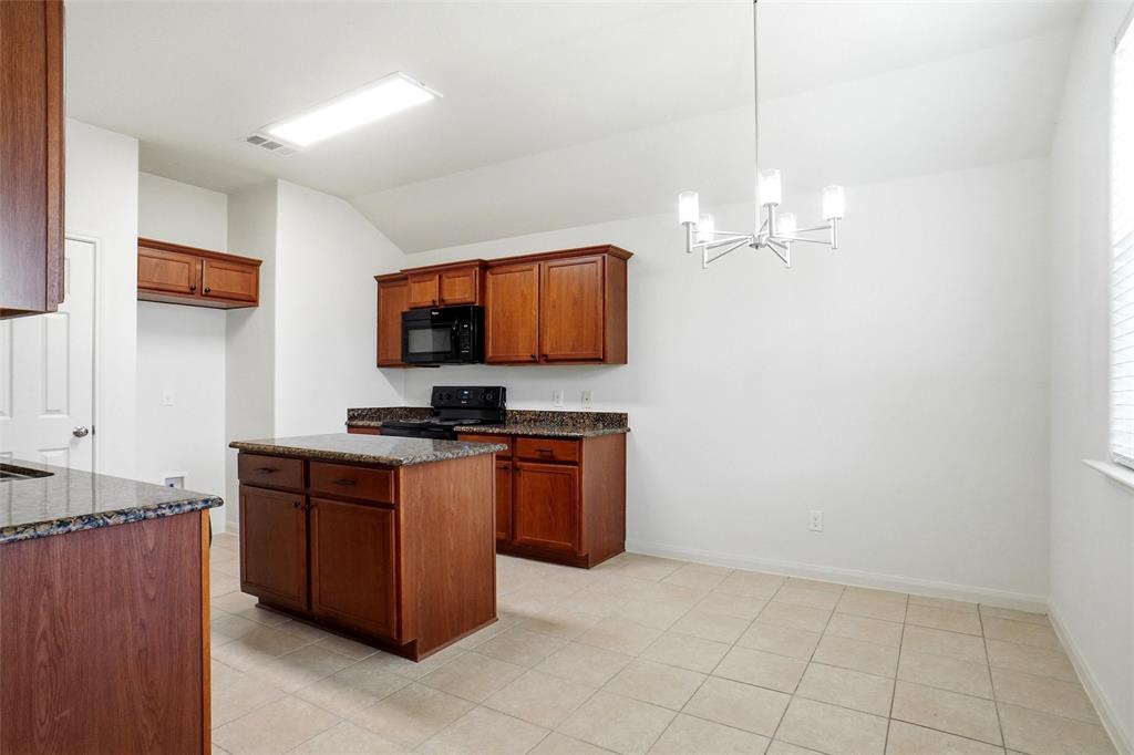 216 Meadow Ridge Drive Anna, TX 75409 - Photo 7 of 16 a kitchen with stainless steel appliances granite countertop a sink and a stove