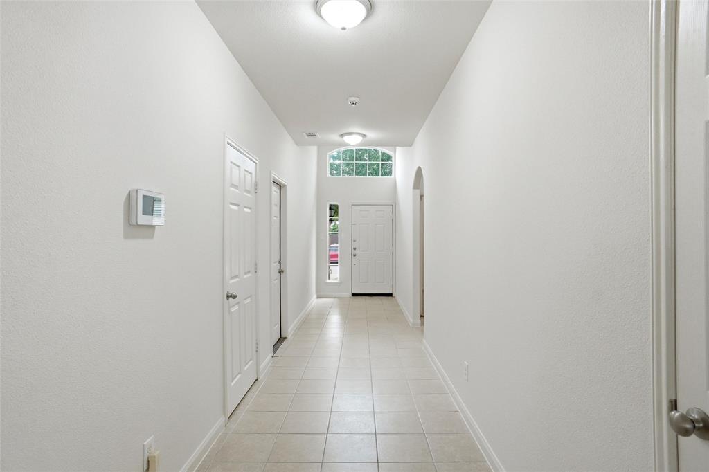 216 Meadow Ridge Drive Anna, TX 75409 - Photo 10 of 16 a view of a hallway with wooden shelves