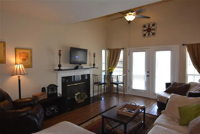 a living room with furniture a fireplace and a flat screen tv