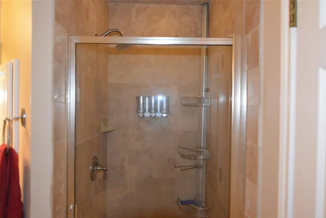 a bathroom with a glass shower door