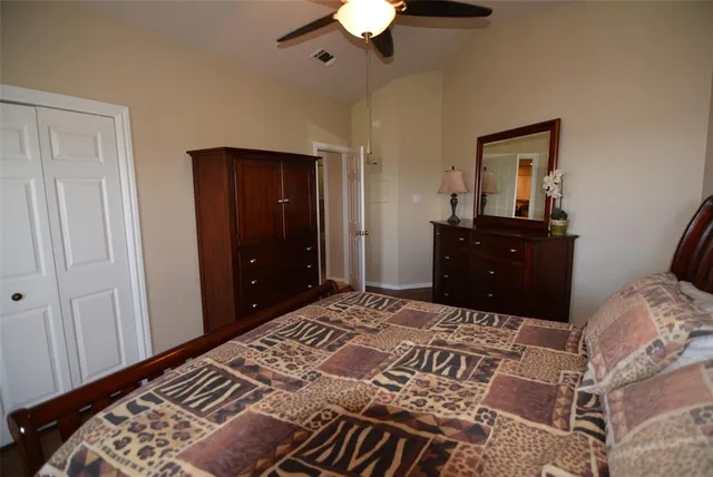 a bedroom with a bed and a dresser