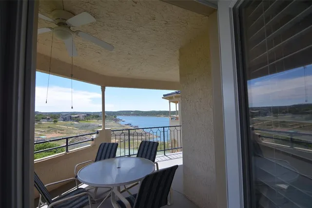a view of a balcony with chairs and a table
