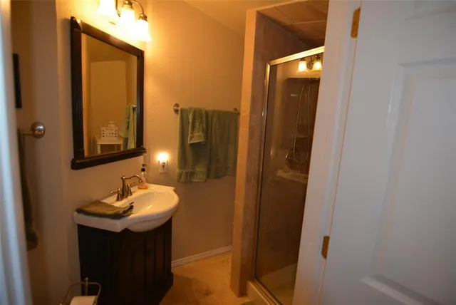 a bathroom with a sink a mirror and vanity