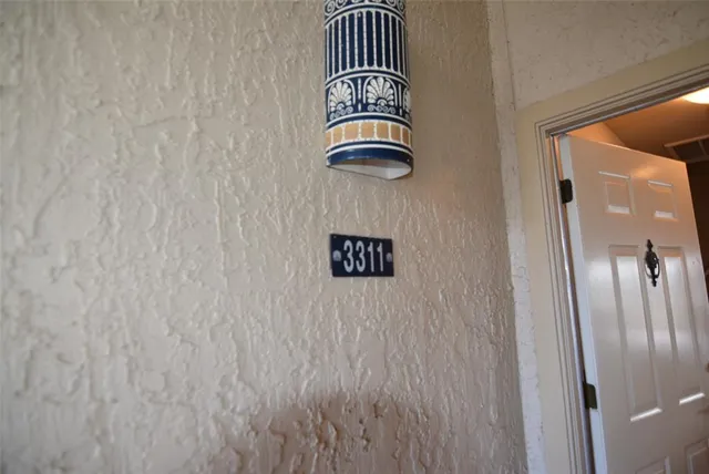a living room with furniture a chandelier and a flat screen tv