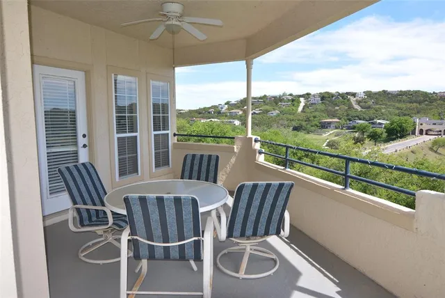 a view of a city from a balcony with furniture