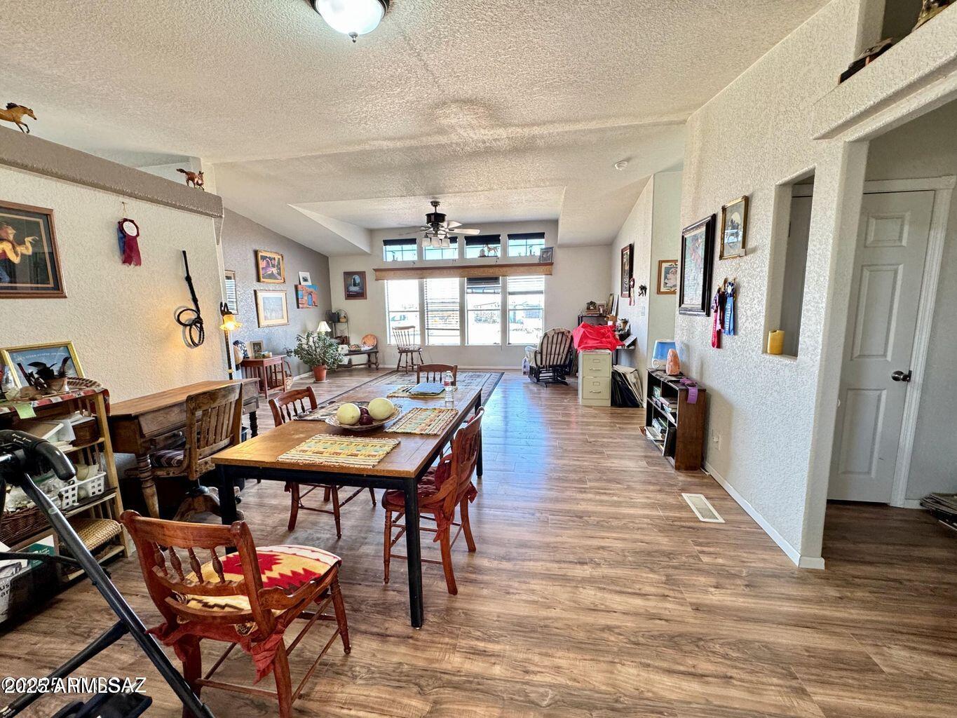2627 West Hansen Road Willcox, AZ 85643 - Photo 11 of 42 a view of a dining room with furniture and wooden floor