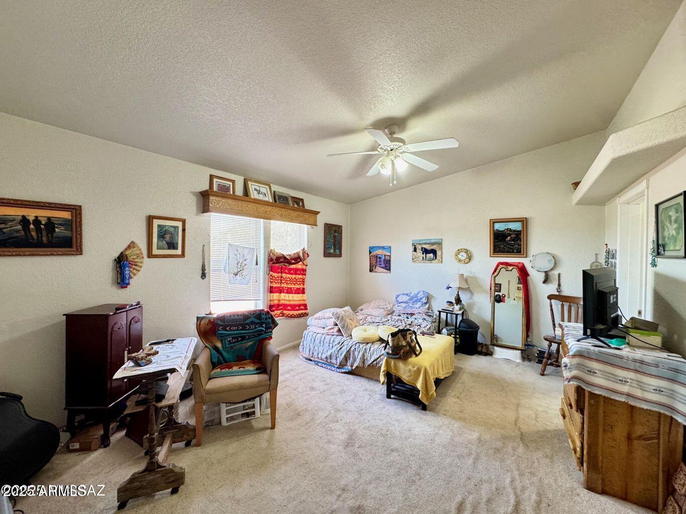 2627 West Hansen Road Willcox, AZ 85643 - Photo 16 of 42 a bedroom with furniture and a chandelier