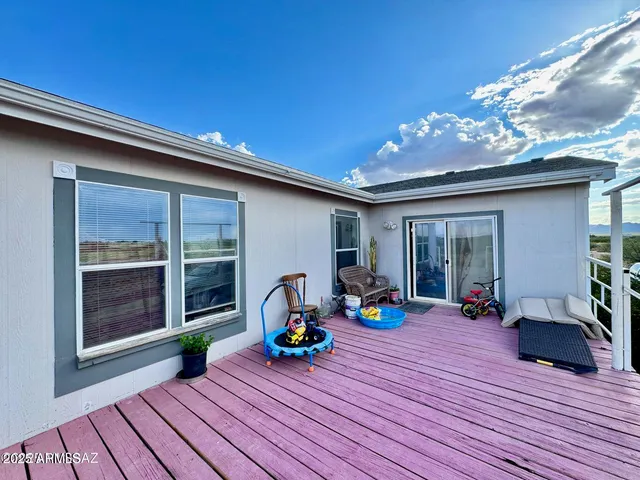 a view of a balcony with yard