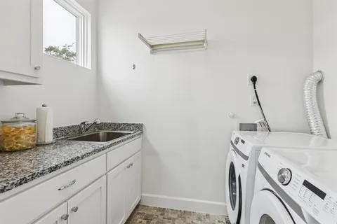 a bathroom with a granite countertop sink a toilet and a shower